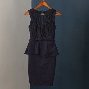 Form-fitting navy peplum dress